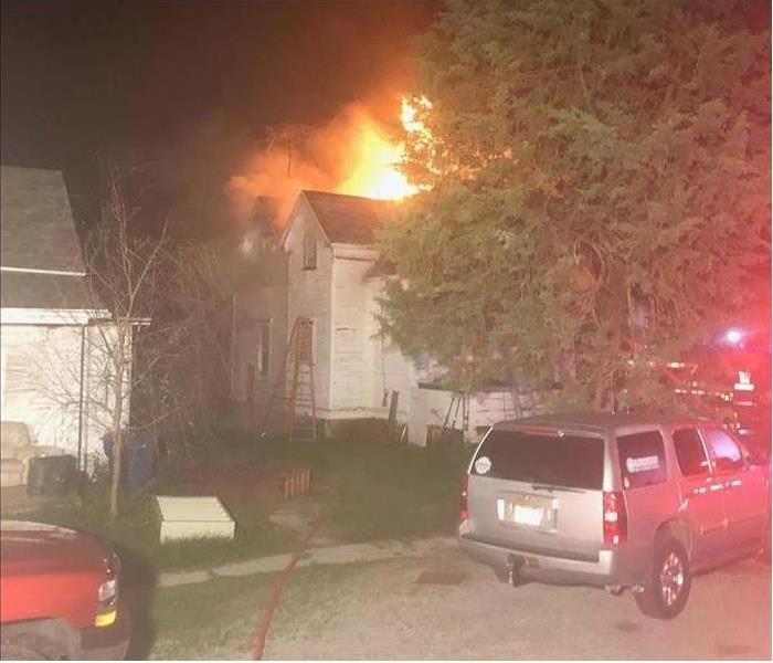 Home on Fire with flames coming out of roof